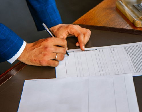 person-writing-on-white-form-paper.jpg person writing on white form paper